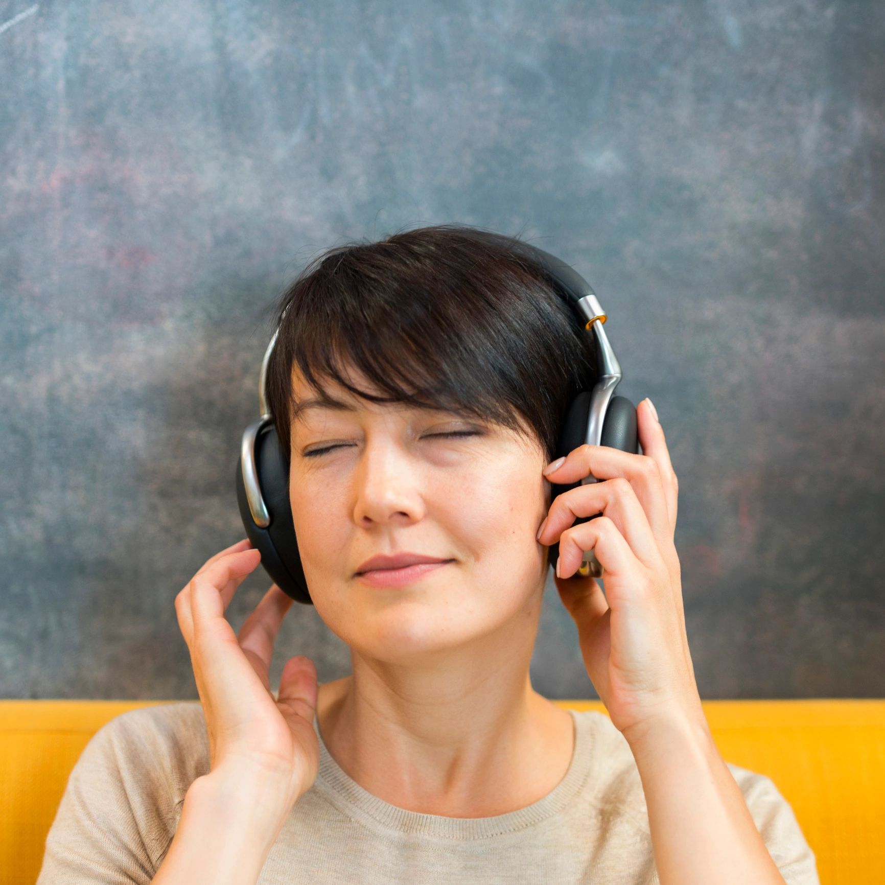 Young woman enjoying music through headphones